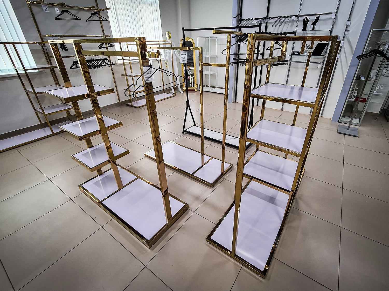 Торговое оборудование золотого цвета в интерьере магазина Торговое оборудование золотого цвета в интерьере магазина